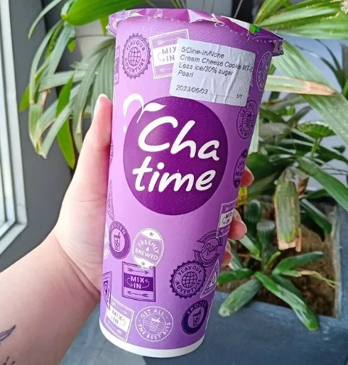 at cha time Malaysia a parson carrying Fresh fruit juice glass