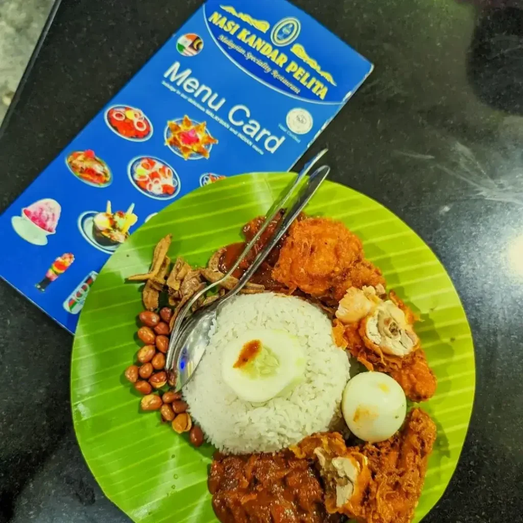 Nasi means rice, lemak means fat, & Ayam means fried chicken menu card on Side